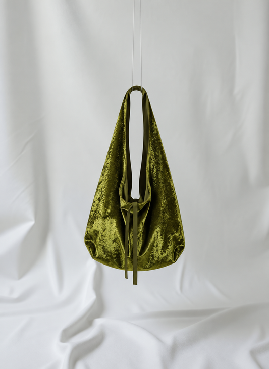 Golden olive green crushed velvet bag hanging from the ceiling, made by Esra Kayira brand.