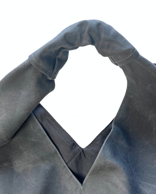 Gray waxed canvas origami midi bag texture and material detail by Esra Kayira brand