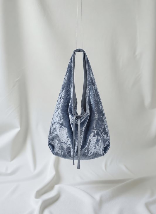 Silver blue crushed velvet bag hanging from the ceiling, made by Esra Kayira brand.