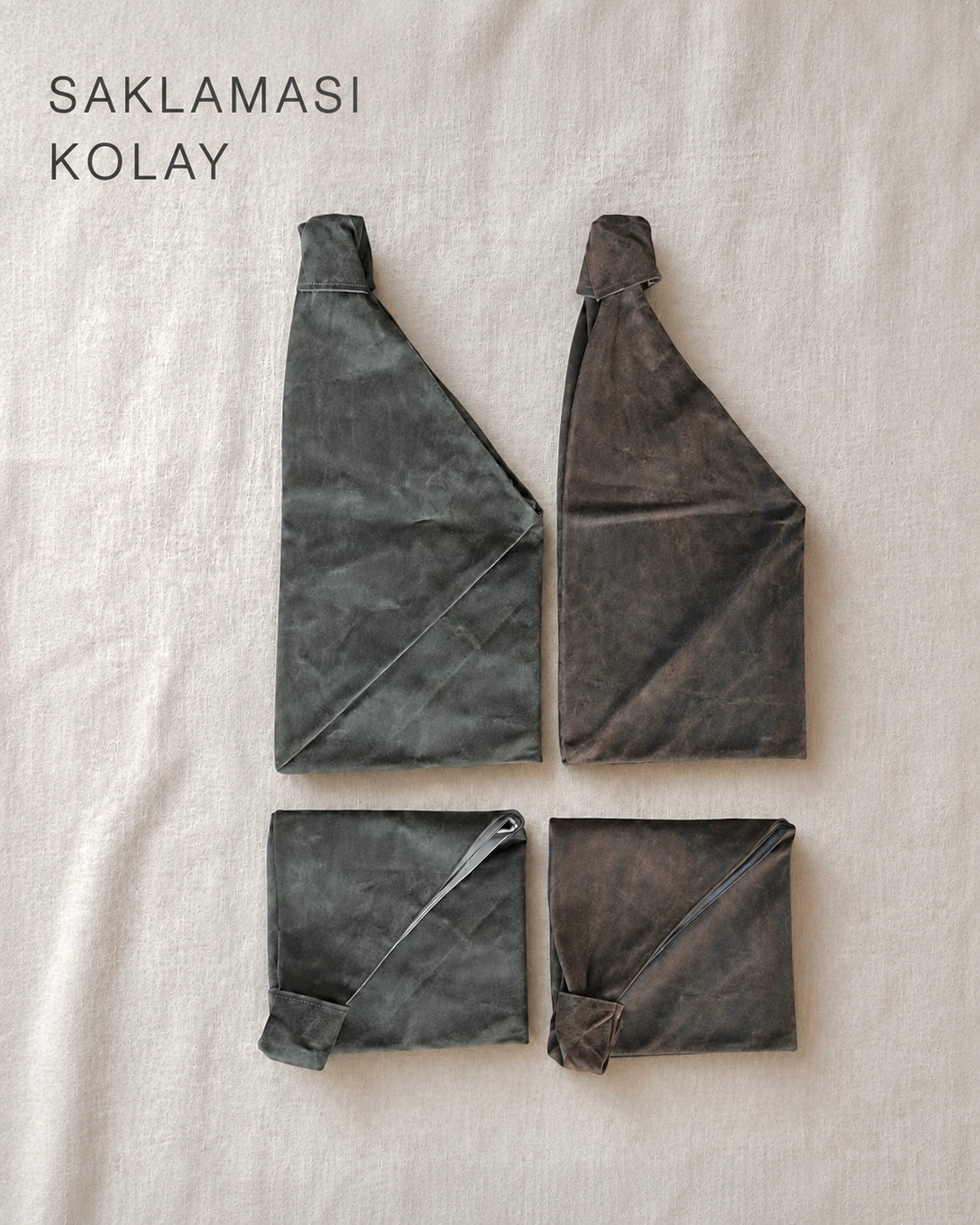 Folded Esra Kayira waxed canvas origam bag on a piece of cloth