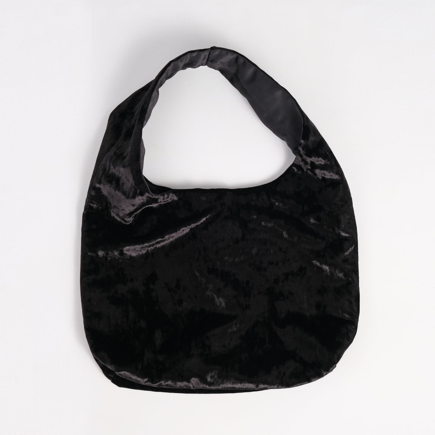 Black crushed velvet over the shoulder bag handmade in Turkey, Esra Kayira brand, flat on white background.