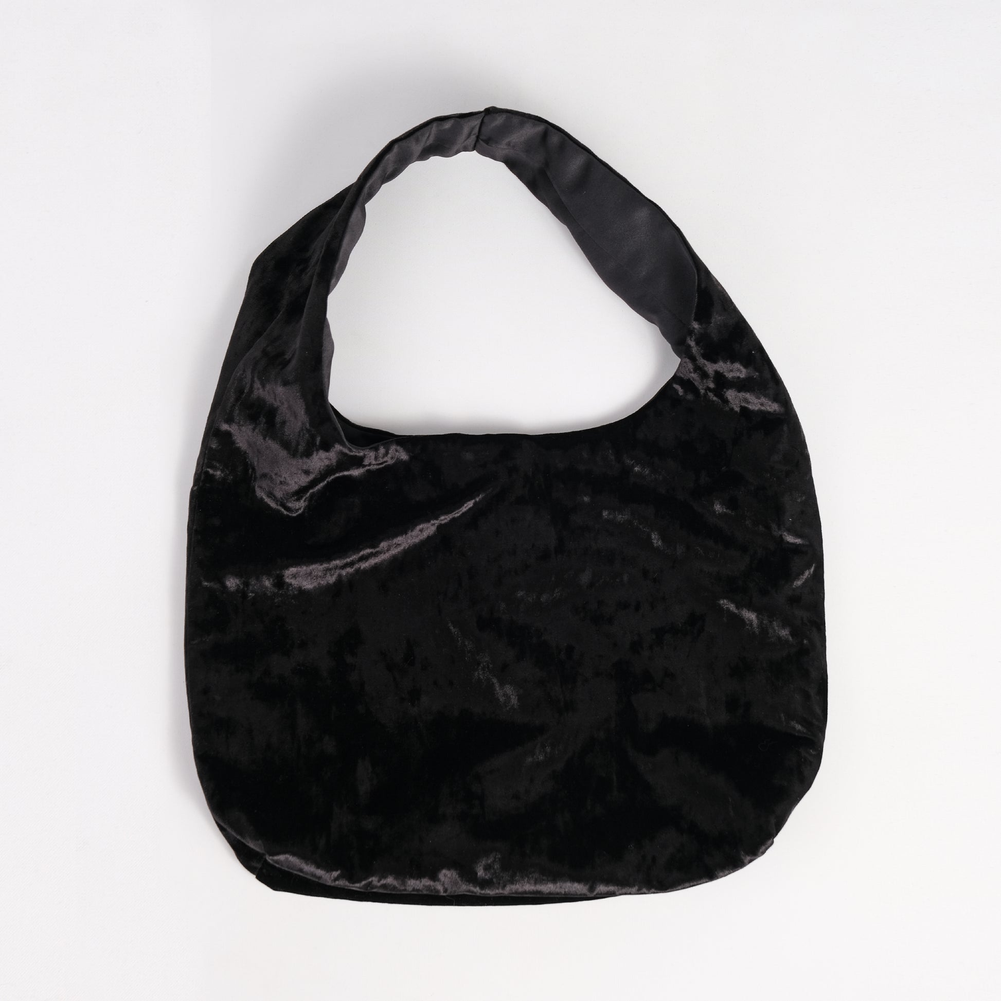 Black crushed velvet over the shoulder bag handmade in Turkey, Esra Kayira brand, flat on white background.