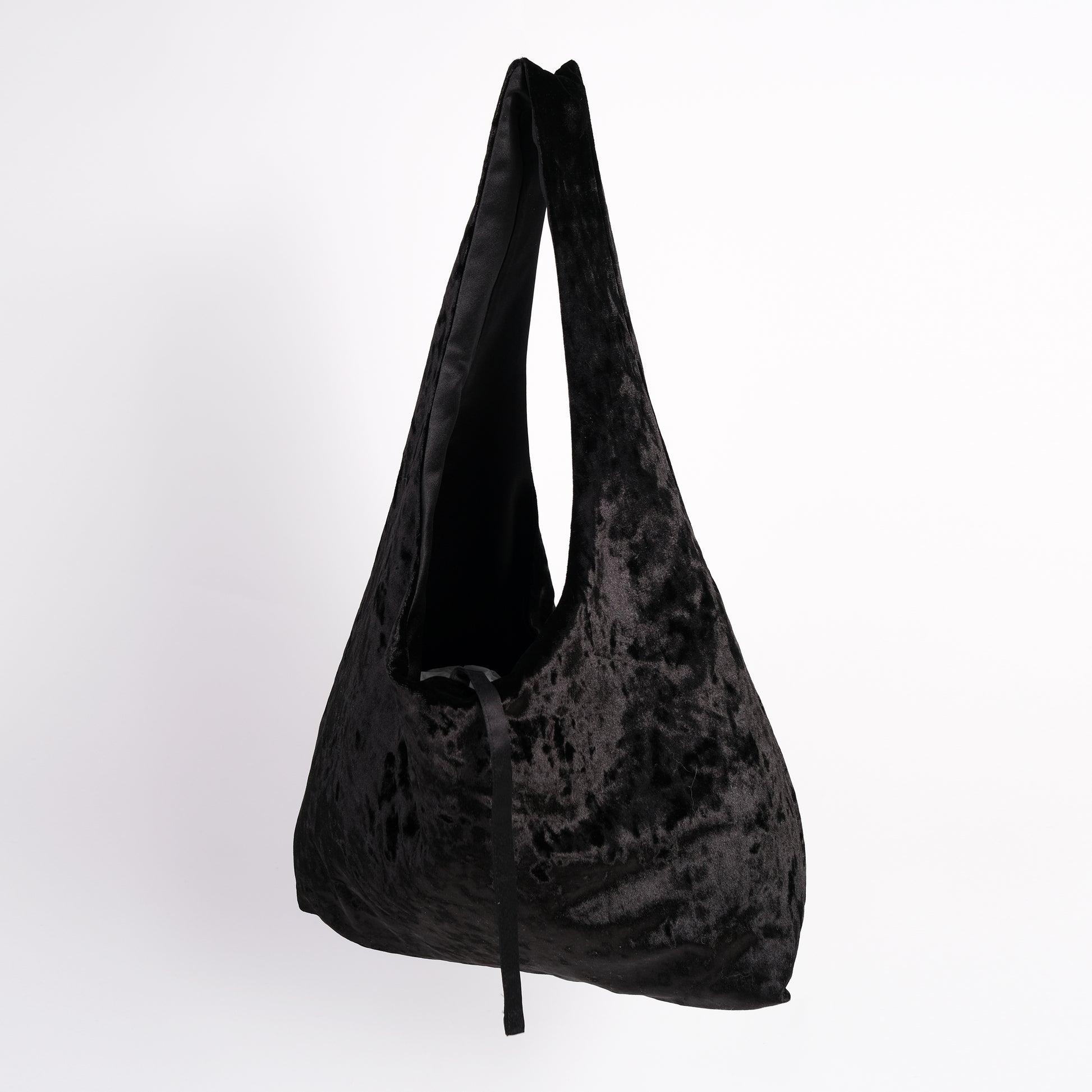 Black crushed velvet over the shoulder bag handmade in Turkey, Esra Kayira brand, hanging.