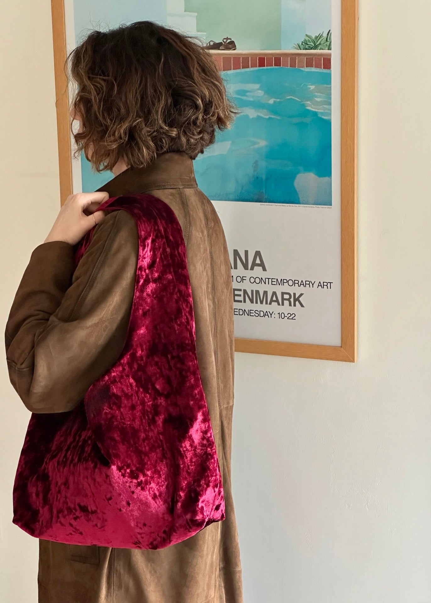 Burgundy crushed velvet bag handmade in Turkey, with model, Esra Kayira brand. 