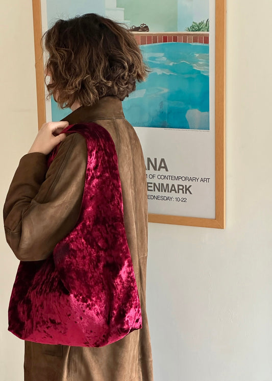 Burgundy crushed velvet bag handmade in Turkey, with model, Esra Kayira brand. 