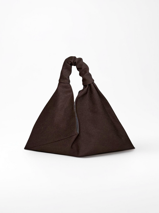 Dark brown, mini size canvas origami bag handmade in Turkey, on a model, by Esra Kayira brand. 