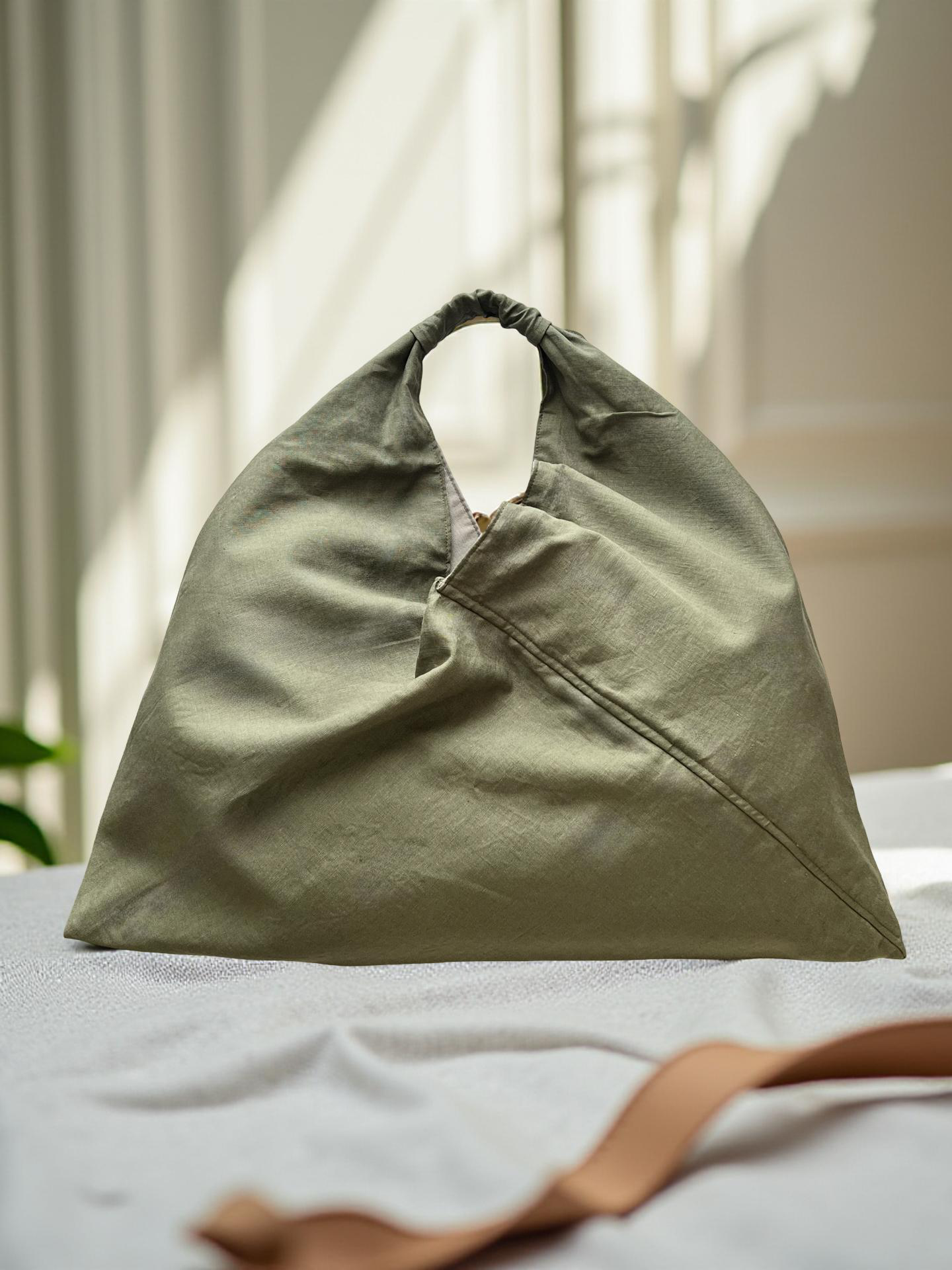 Olive green linen large origami bag handmade in Turkey, Esra Kayira brand, still life.