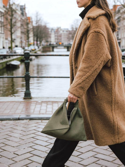 Olive green, mini size canvas origami bag handmade in Turkey, on a model, by Esra Kayira brand. 